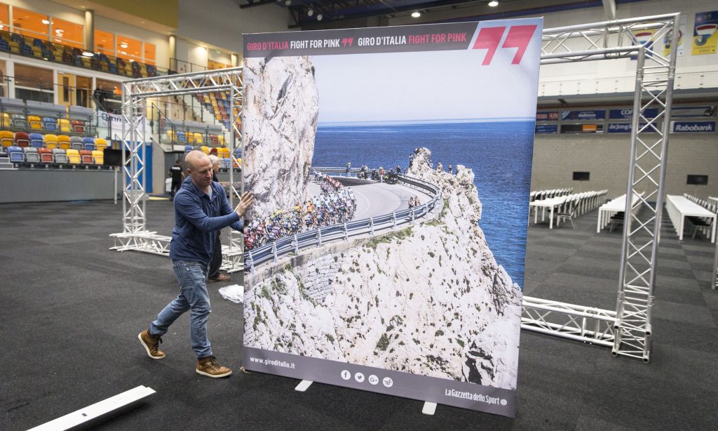 A man carries a poster of the Giro d'Italia cyling race at the Omnisport centre in Apeldoorn, on May 2, 2016. The Giro d'Italia will start in Apeldoorn on May 6, 2016. / AFP / ANP / Jerry Lampen / Netherlands OUT (Photo credit should read JERRY LAMPEN/AFP/Getty Images)
