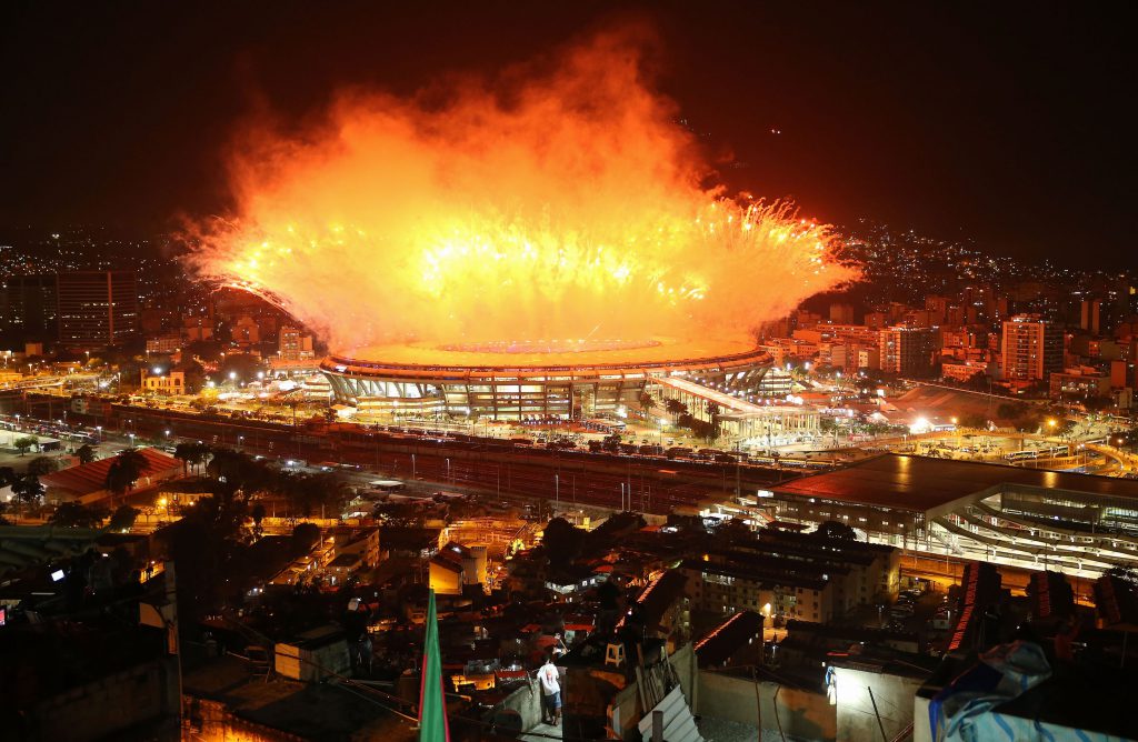 RIO DE JANEIRO, BRAZIL - AUGUST 05: Fireworks explode over Maracana stadium with the Mangueira 'favela' community in the foreground during opening ceremonies for the Rio 2016 Olympic Games on August 5, 2016 in Rio de Janeiro, Brazil. The Rio 2016 Olympic Games commenced tonight at the iconic stadium. (Photo by Mario Tama/Getty Images)