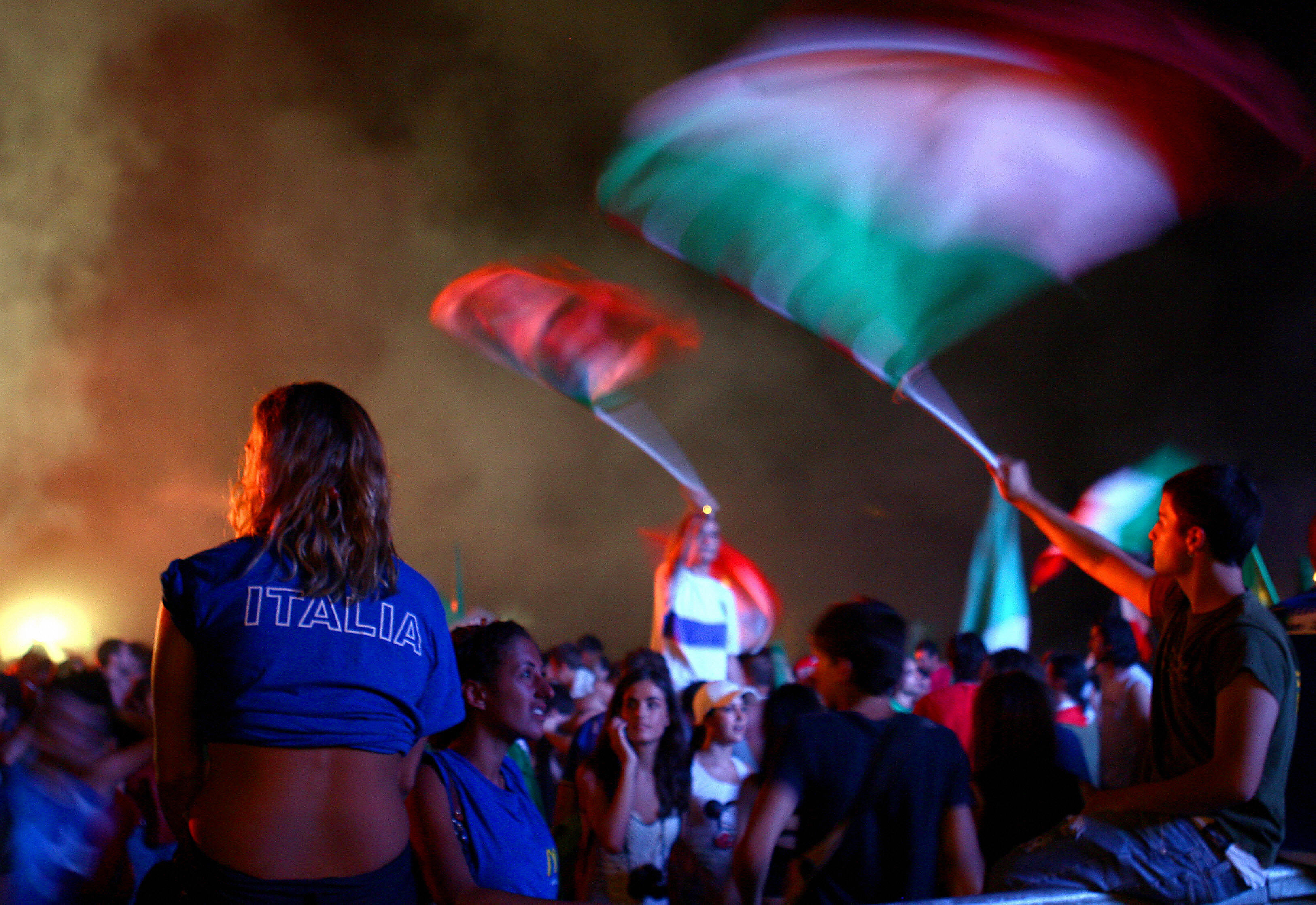 Rome, ITALY: Italian football fans celebrate in Rome's Circo Massimo 04 July 2006 after Italy won the World Cup semi-final match against Germany. Italy scored two sensational late goals in extra-time to book their place in the World Cup final for the first time in 12 years with their 2-0 win crushing the dreams of host nation Germany. AFP PHOTO / VINCENZO PINTO (Photo credit should read VINCENZO PINTO/AFP/Getty Images)