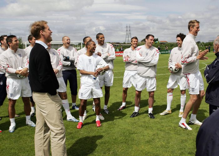 MANCHESTER, UNITED KINGDOM - JUNE 1: (THIS PICTURE CAN ONLY BE USED WITHIN THE CONTEXT OF AN EDITORIAL FEATURE. NO WEBSITE/INTERNET USE UNLESS SITE IS REGISTERED WITH FOOTBALL ASSOCIATION PREMIER LEAGUE) Peter Crouch of England (R) performs his now famous goal celebration - the 'robot' dance - for HRH Prince William (L) and the rest of the England World Cup squad during training ahead of the International Friendly against Jamaica on June 1, 2006 in Carrington, Manchester. (Photo by Simon Mooney-Pool/Getty Images)
