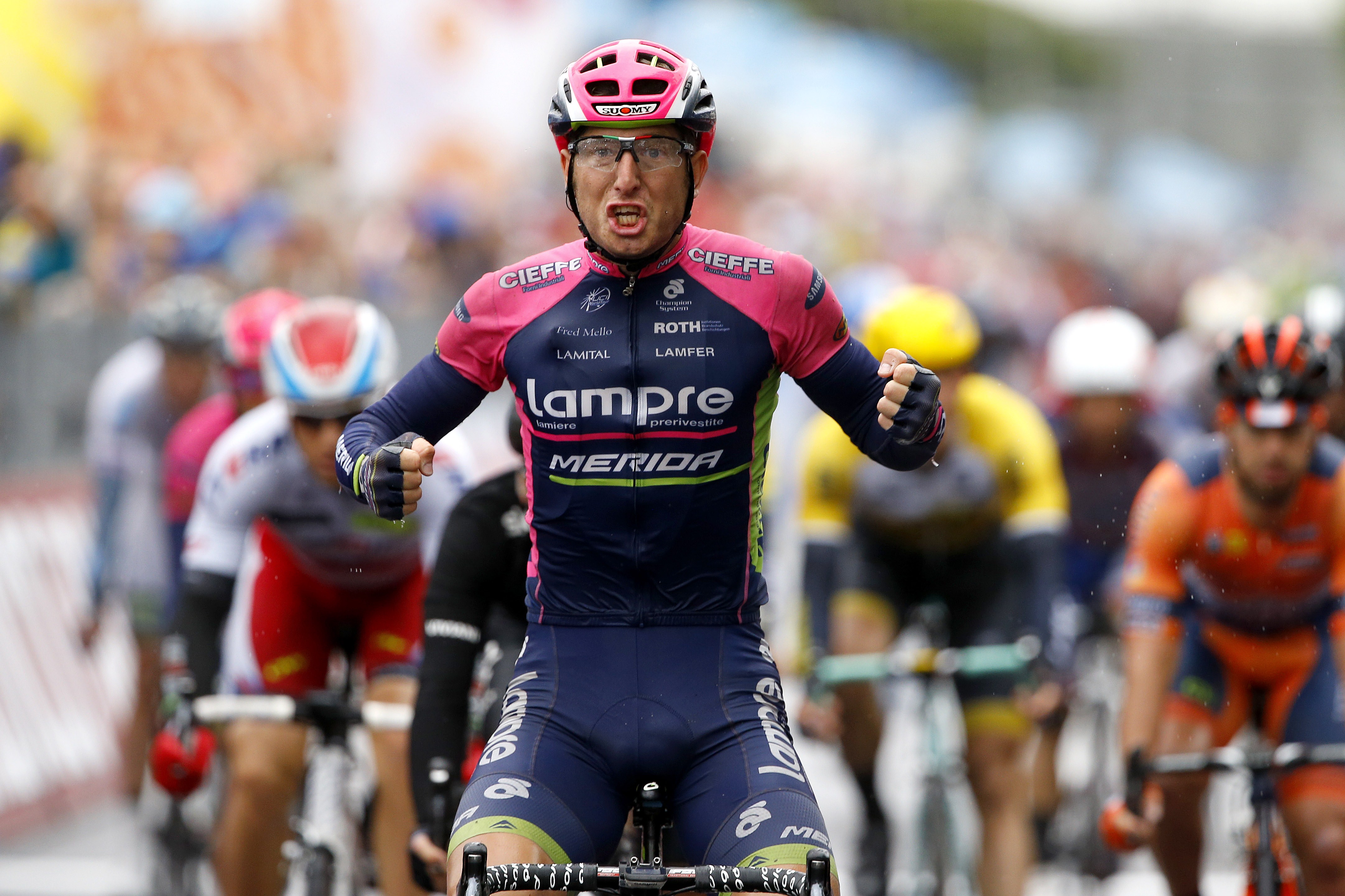Italian rider Sacha Modolo (Lampre Merida) celebrates as he crosses the finish line to win the 13th stage of the 98th Giro d'Italia, Tour of Italy, cycling race between Montecchio Maggiore and Jesolo on May 22, 2015 in Jesolo. AFP PHOTO / LUK BENIES (Photo credit should read LUK BENIES/AFP/Getty Images)