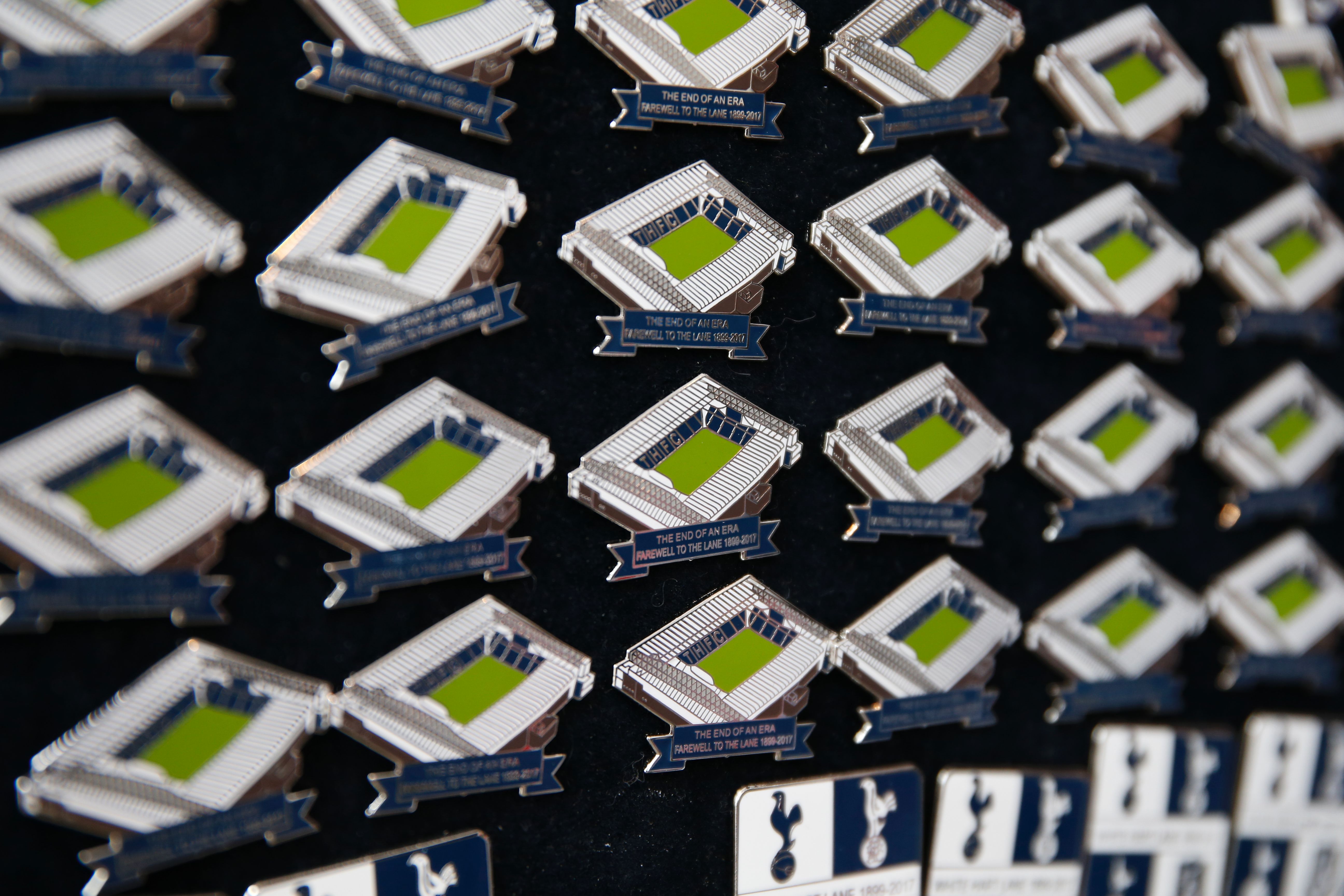 Pin badges in the shape of the stadium are sold outside White Hart Lane in London, on May 14, 2017 ahead of the English Premier League football match between Tottenham Hotspur and Manchester United, the final football match to be played in the stadium before it is torn down with a new stadium being developed next door. / AFP PHOTO / IKIMAGES / Ian KINGTON / RESTRICTED TO EDITORIAL USE. No use with unauthorized audio, video, data, fixture lists, club/league logos or 'live' services. Online in-match use limited to 45 images, no video emulation. No use in betting, games or single club/league/player publications. (Photo credit should read IAN KINGTON/AFP/Getty Images)