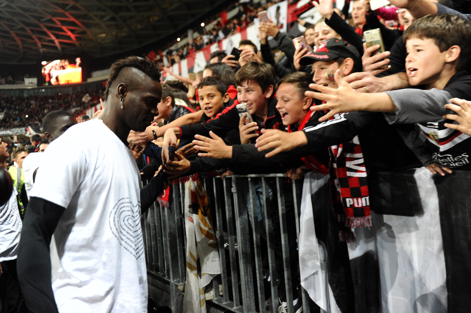 Nice's Italian forward Mario Balotelli celebrates with supporters at the end of the French L1 football match Nice vs Angers on May 14, 2017, at the Allianz Riviera stadium in Nice, southeastern France. / AFP PHOTO / Franck PENNANT (Photo credit should read FRANCK PENNANT/AFP/Getty Images)